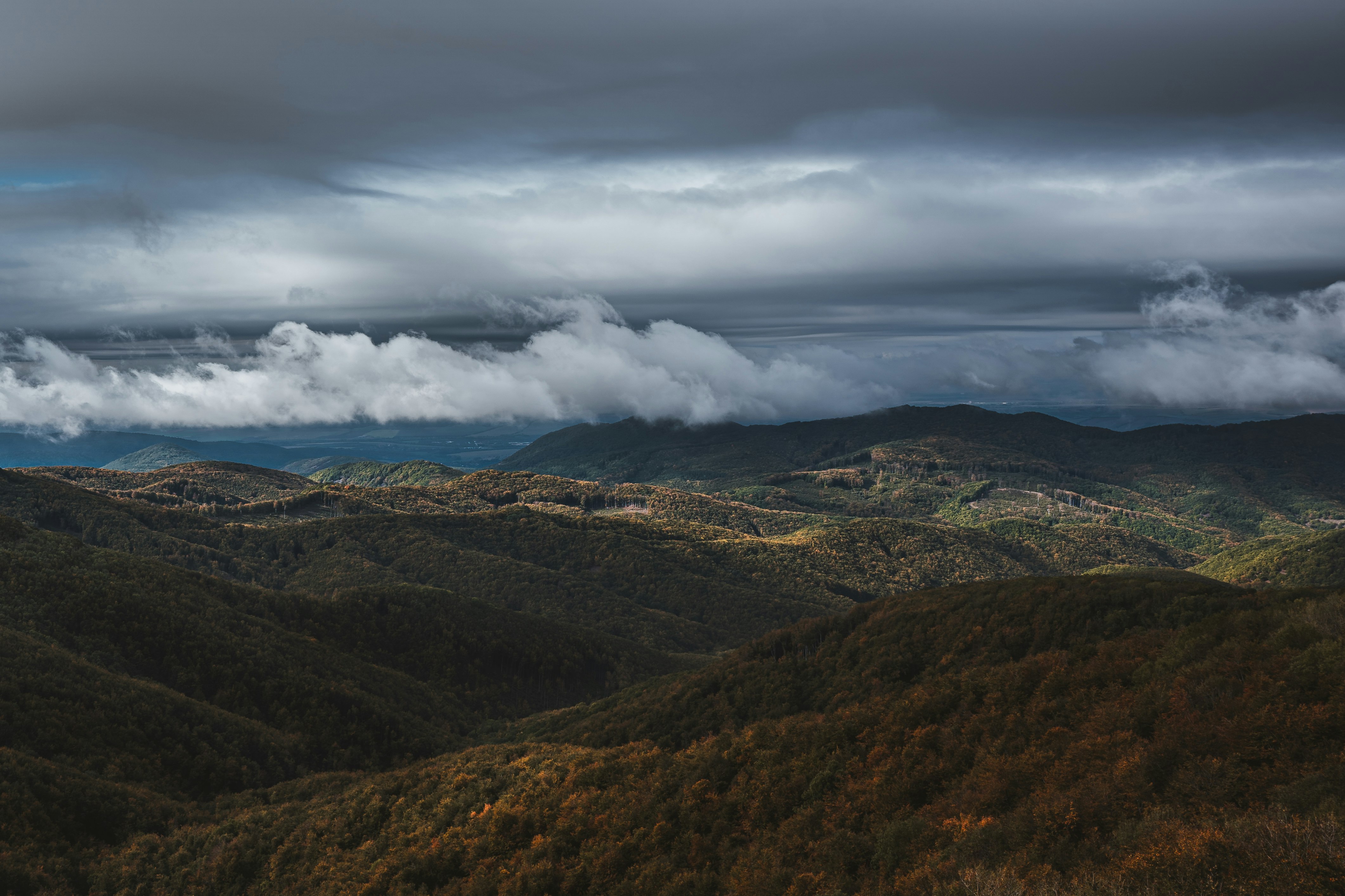 green and brown mountains under white clouds during daytime